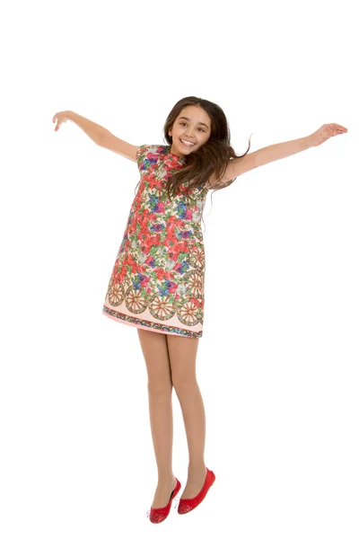 Beautiful teen girl jumping hands wide apart — Stock Photo, Image