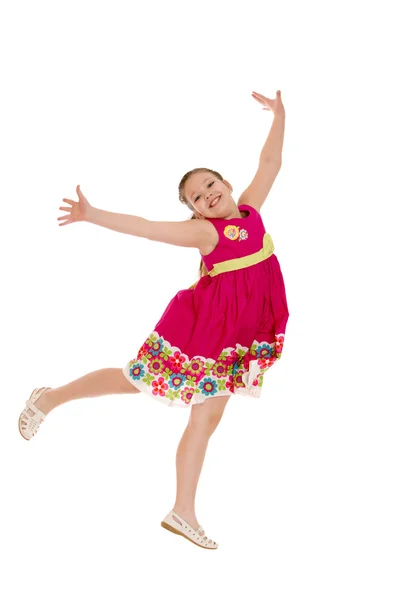 Cheerful girl in a jump, hands wide apart — Stock Photo, Image