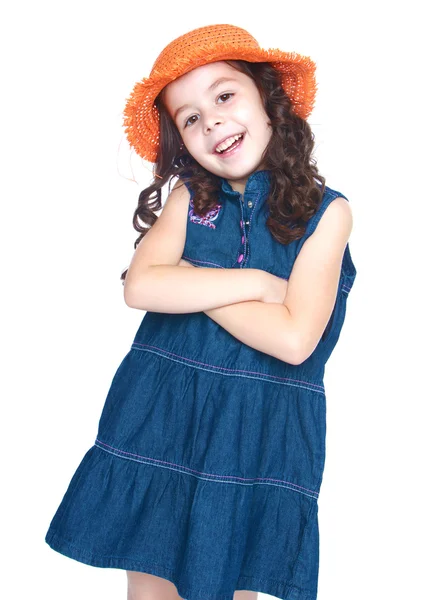 Chica sonriente en un vestido de mezclilla y sombrero naranja —  Fotos de Stock