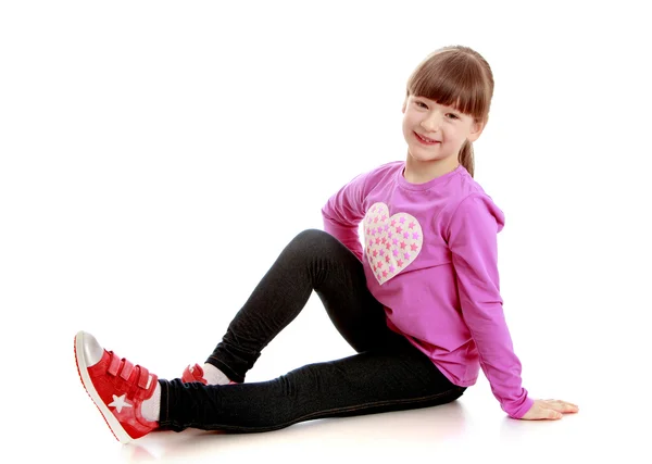 Girl sitting on white background — Stock Photo, Image