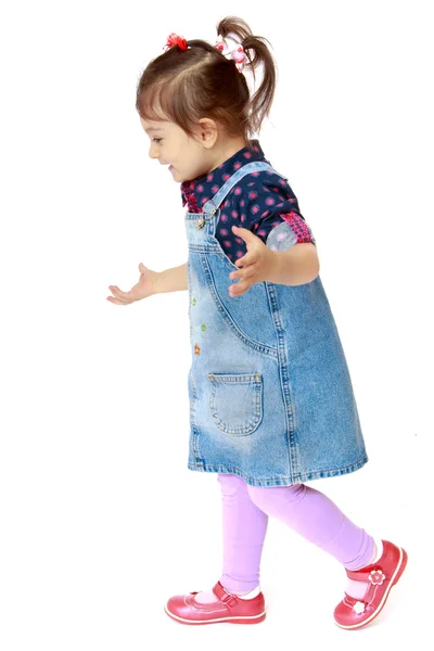 Little girl in a denim dress on white background — Stock Photo, Image