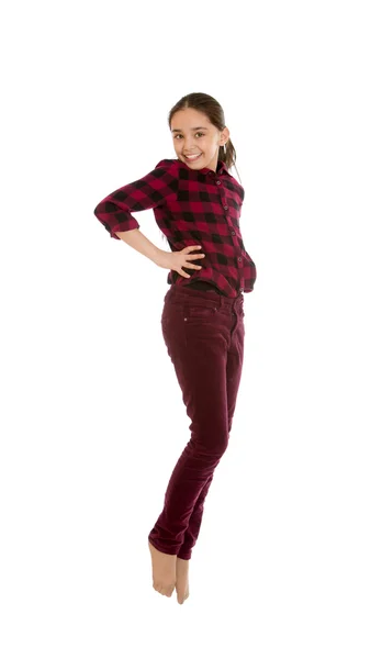 Dívka v košili a kalhotách skoky — Stock fotografie