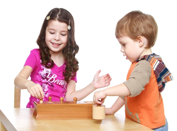 Brother and sister playing at the table. — Stock Photo, Image