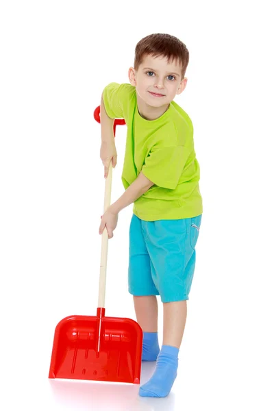 Funny boy with a shovel in his hands. — Stock Photo, Image