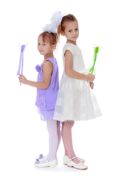 Two well-dressed girl holding a magic wand — Stock Photo, Image