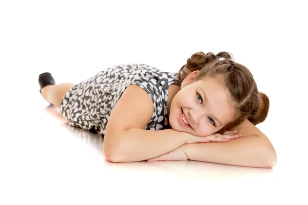 Dreaming of a beautiful girl lying on the floor with your hands — Stock Photo, Image