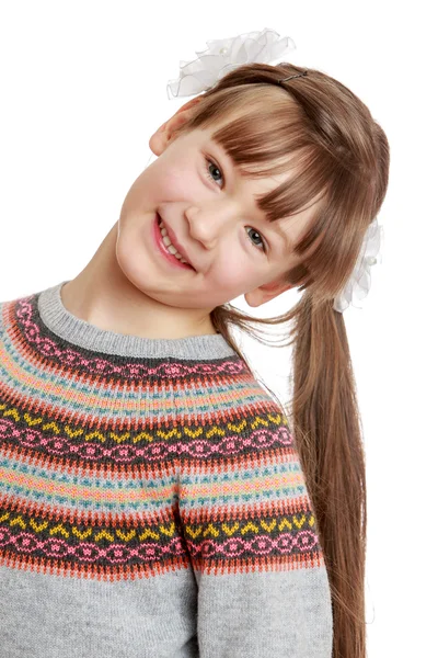 Beautiful girl with long tails looks into the camera and smiles — Stock Photo, Image