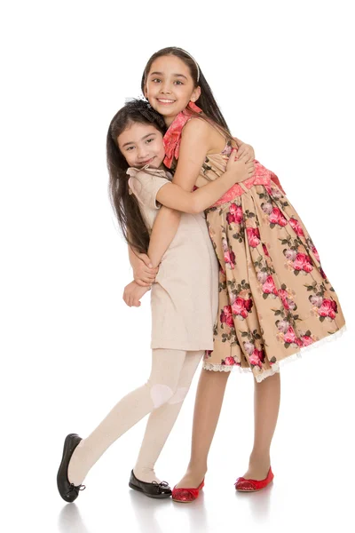 Beautiful fashion little girls sisters hugging — Stock Photo, Image