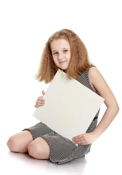 Charming schoolgirl holds a placard go on the floor — Stock Photo, Image