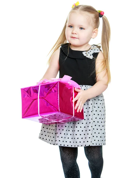 Adorable little girl with long ponytails on her head holding a b — Stock Photo, Image