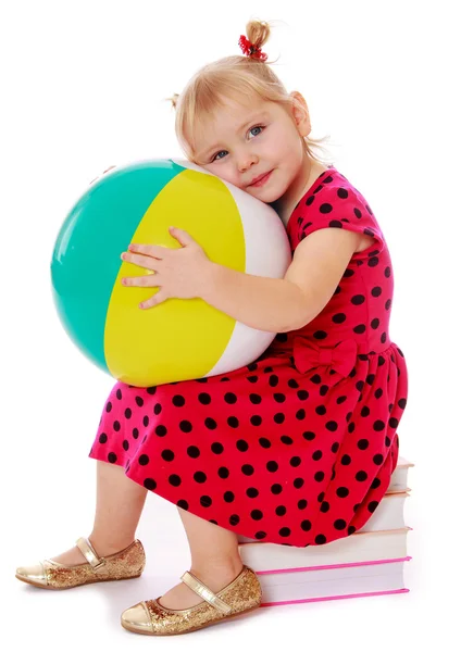 Little girl in a red dress with polka dots — Stock Photo, Image