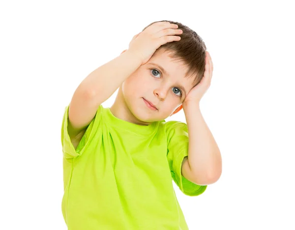 Portrait of a little boy who is holding his head with hands , cl — Stock Photo, Image