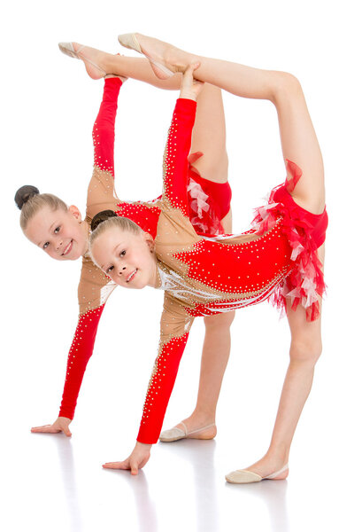 Sisters twins girls beautiful tracksuits demonstrate the exercis