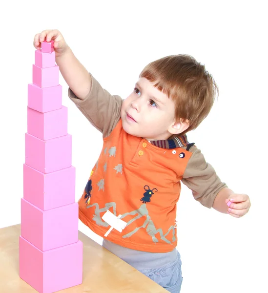 Little boy learn to put pink pyramid in Montessori kindergarten — Stock Photo, Image