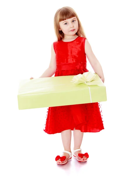 Girl in long red dress holding a large box of beautifully packag — Stock Photo, Image