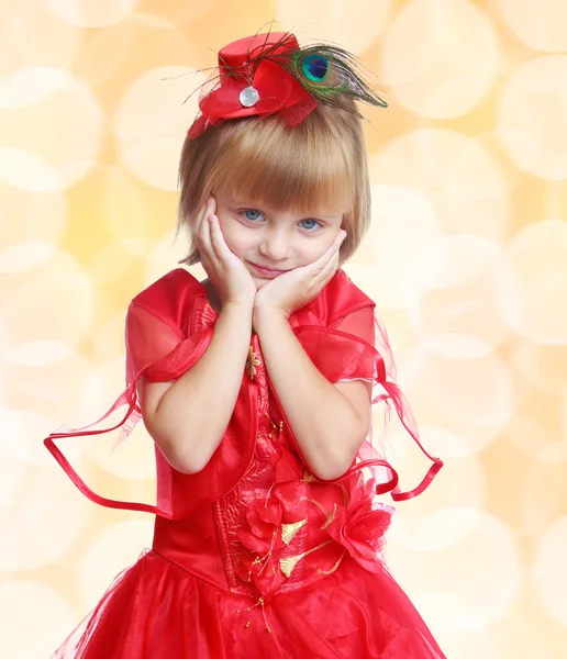 Stylish little girl in a red dress, close-up, pale yellow backgr — Stock Photo, Image