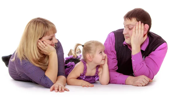 Happy family of three mom dad and little daughter lying on the f — Stock Photo, Image