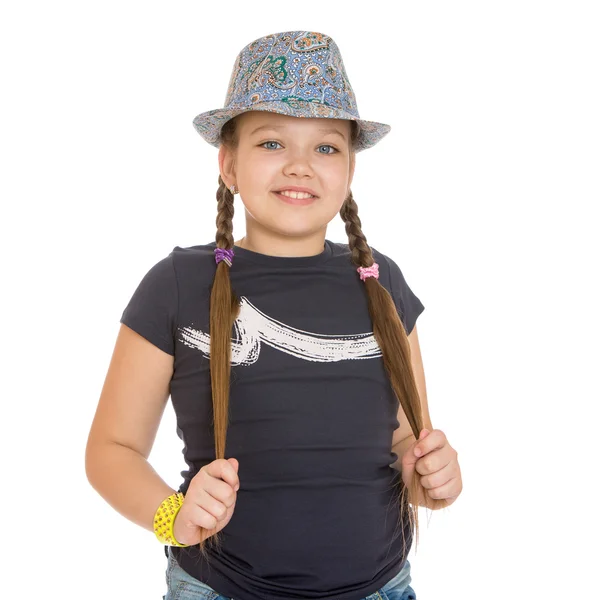 Teenage girl in a hat twitches his braids , close-up — Stock Photo, Image