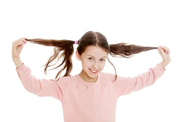 Dark-haired girl twitches his braids , close-up — Stock Photo, Image