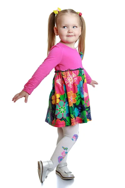 Cute little blonde girl in a bright dress — Stock Photo, Image