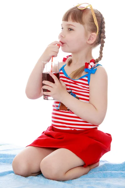 Adorable little girl drinking from a straw juice — Stock Photo, Image