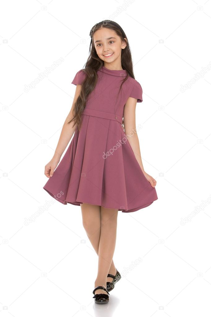 Stylish dark-haired girl in a nice fashionable dress