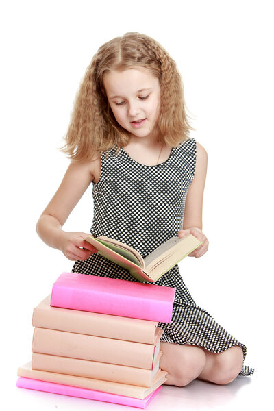 The school age girl reading a book