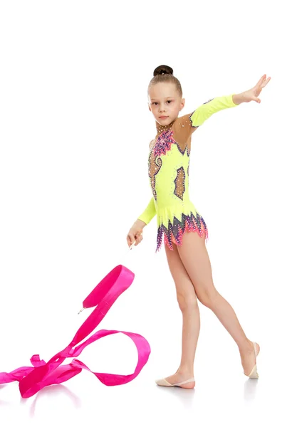 Slender girl gymnast performs exercises with the tape — Φωτογραφία Αρχείου