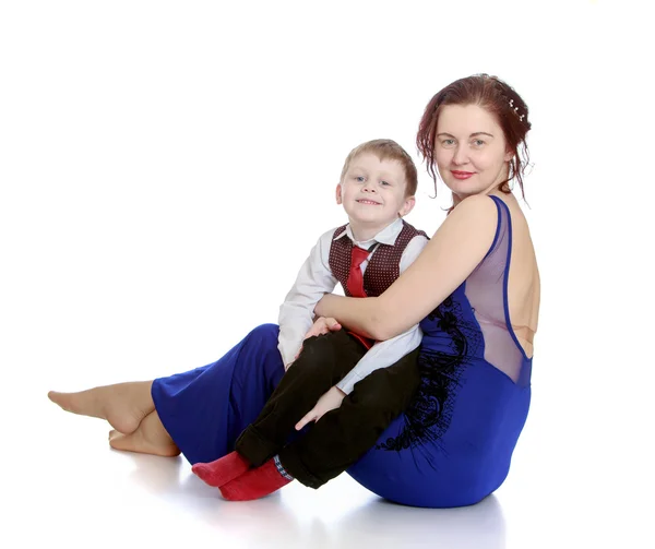 Stylish young mother holding her beloved son — Stock Photo, Image