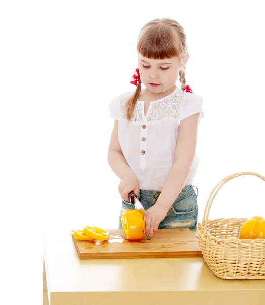 Kid cut with a knife peppers — Stock Photo, Image