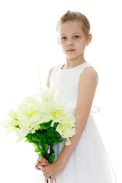 Beautiful girl in a white summer dress holding — Stock Photo, Image