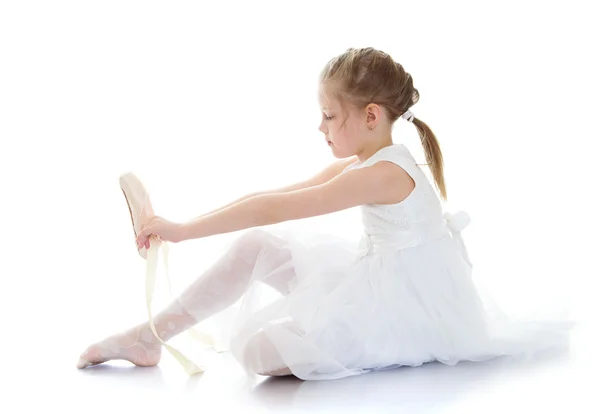 Lovely little girl acrobat or ballerina in a white dress wearing shoes — 스톡 사진