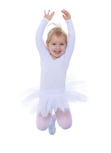 The little Girl is an acrobat jumps in a tracksuit — Stockfoto