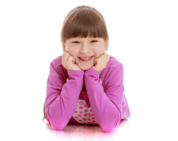 Cheerful girl lying on the floor smiling — Stok fotoğraf