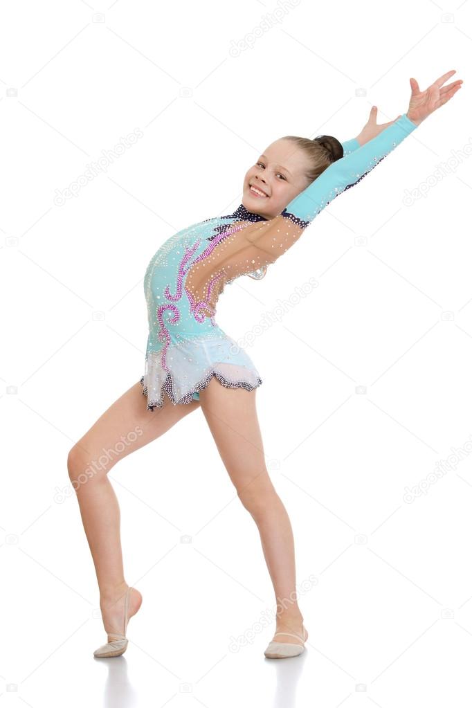 Girl gymnast doing exercises smiles