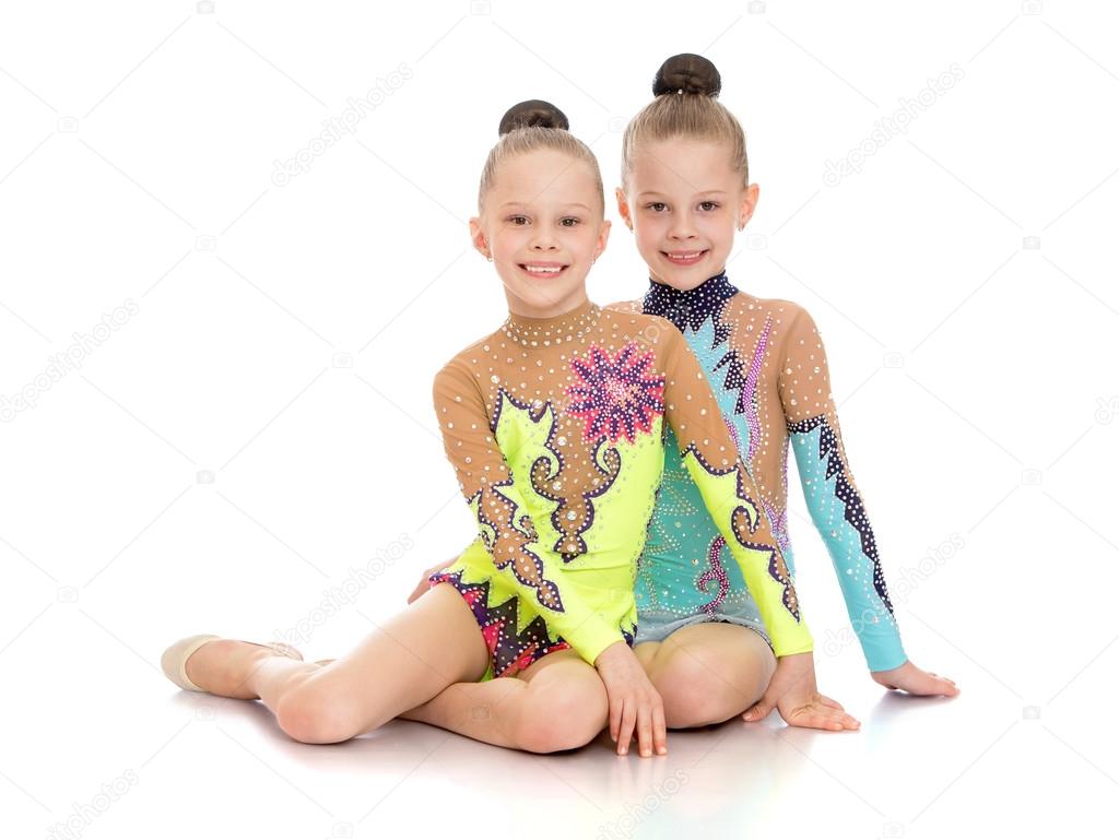 Girls girls sports swimsuits sitting on the floor