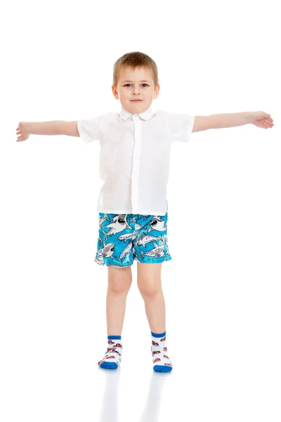 Beautiful little boy in white shirt , shorts and socks are widel — Stok fotoğraf