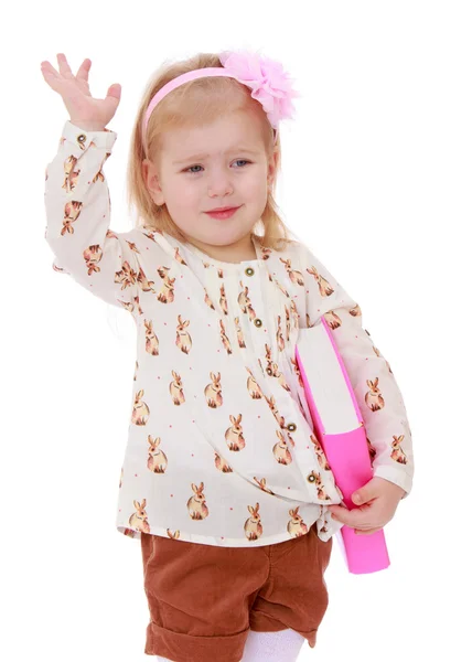 Funny little girl with a bow on her head holding — Stock Photo, Image