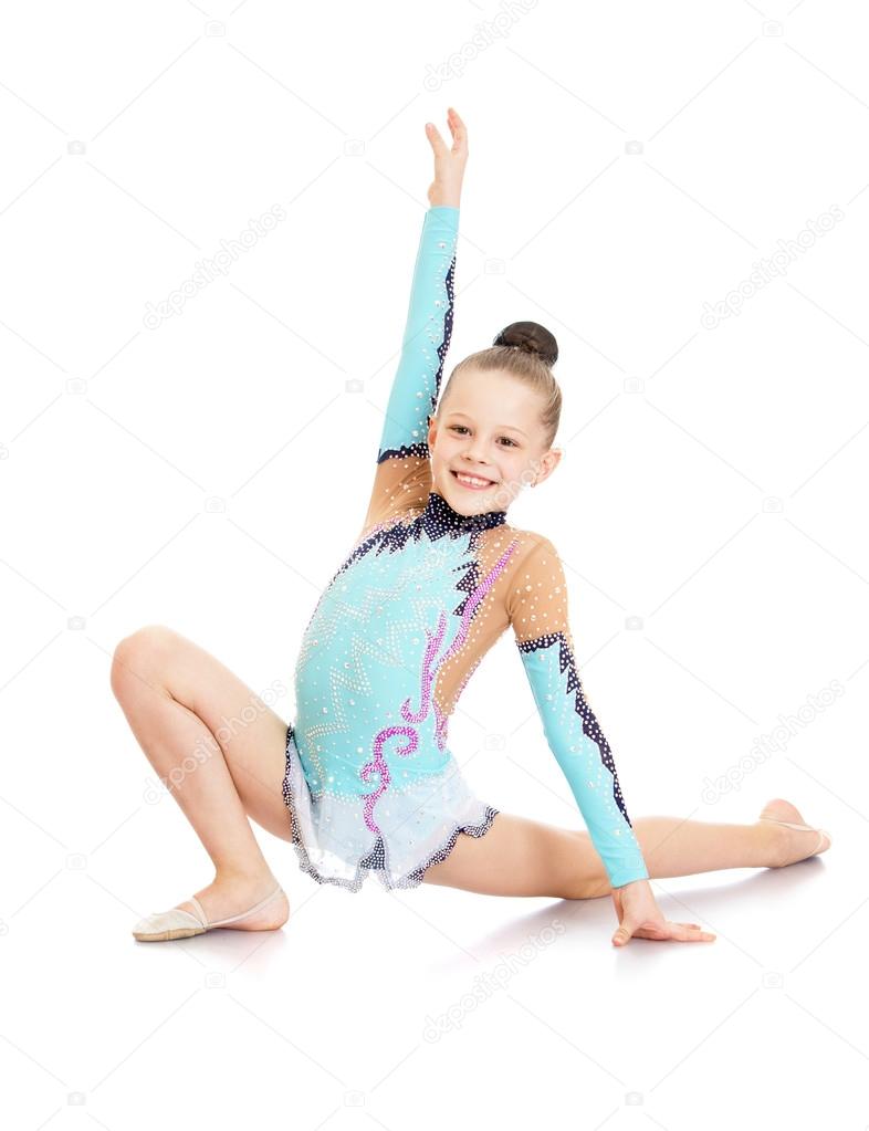 Cheerful girl in a beautiful gymnast sports swimsuit shows exerc