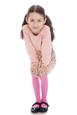 Cheerful girl in a dress and pink cardigan liked put his hands o