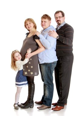 Happy family pregnant mom , dad, older brother and little charmi