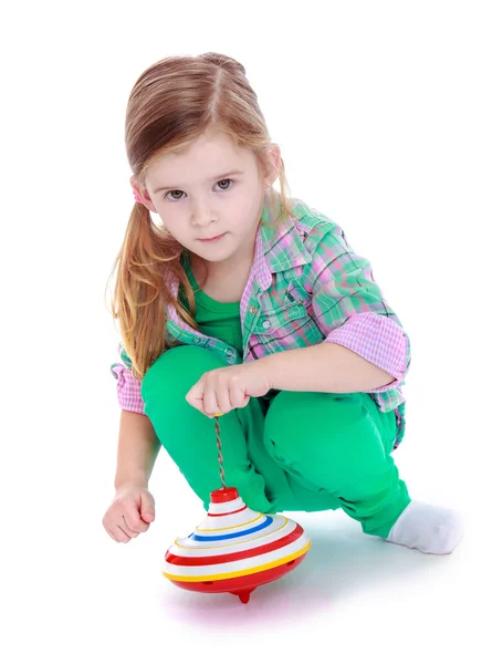 Portrait of little adorable girl blonde which spins the dreidel — Stock Photo, Image