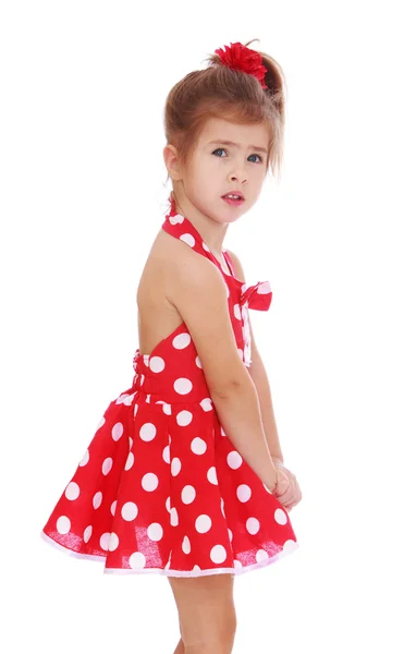 Beautiful little girl in a short red dress — Stok fotoğraf