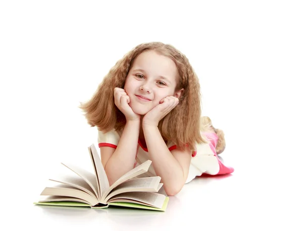 Dreaming schoolgirl with blond flowing short hair lying on the f — Stok fotoğraf