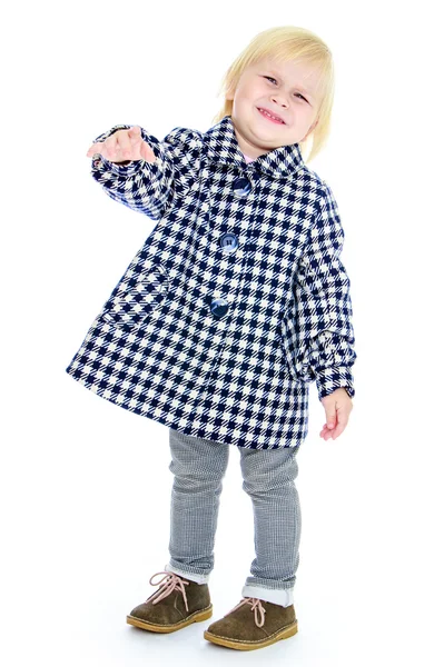 Cute little blonde girl with short hair in autumnal checked coat and jeans — Stok fotoğraf