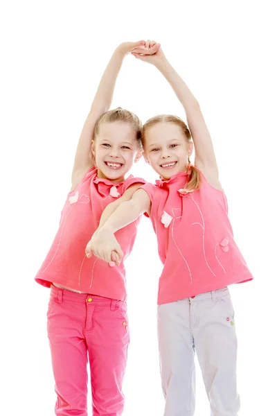 Adorable twin girls fun held hands — ストック写真