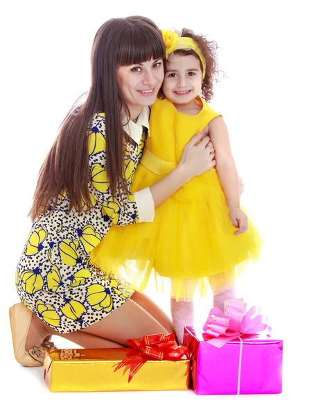 Beautiful fashionable long-haired mom in short dress hugs your f — 图库照片