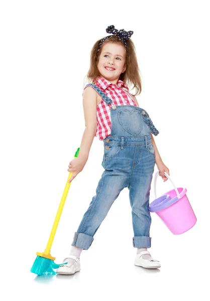 Funny little girl in denim overalls with straps holding — Φωτογραφία Αρχείου