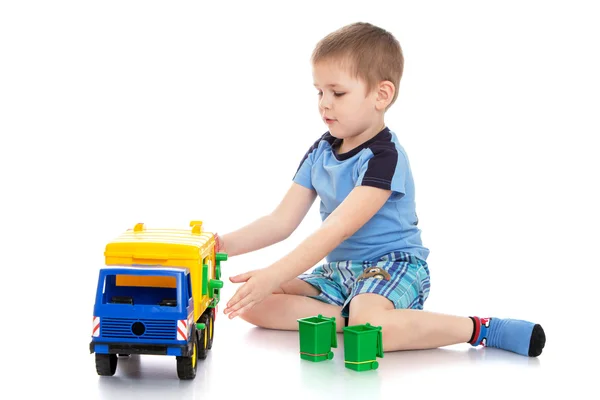 Small blond boy in a blue t-shirt and shorts — Stok fotoğraf