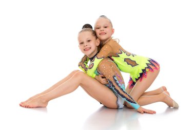 Little gymnasts sitting on the floor